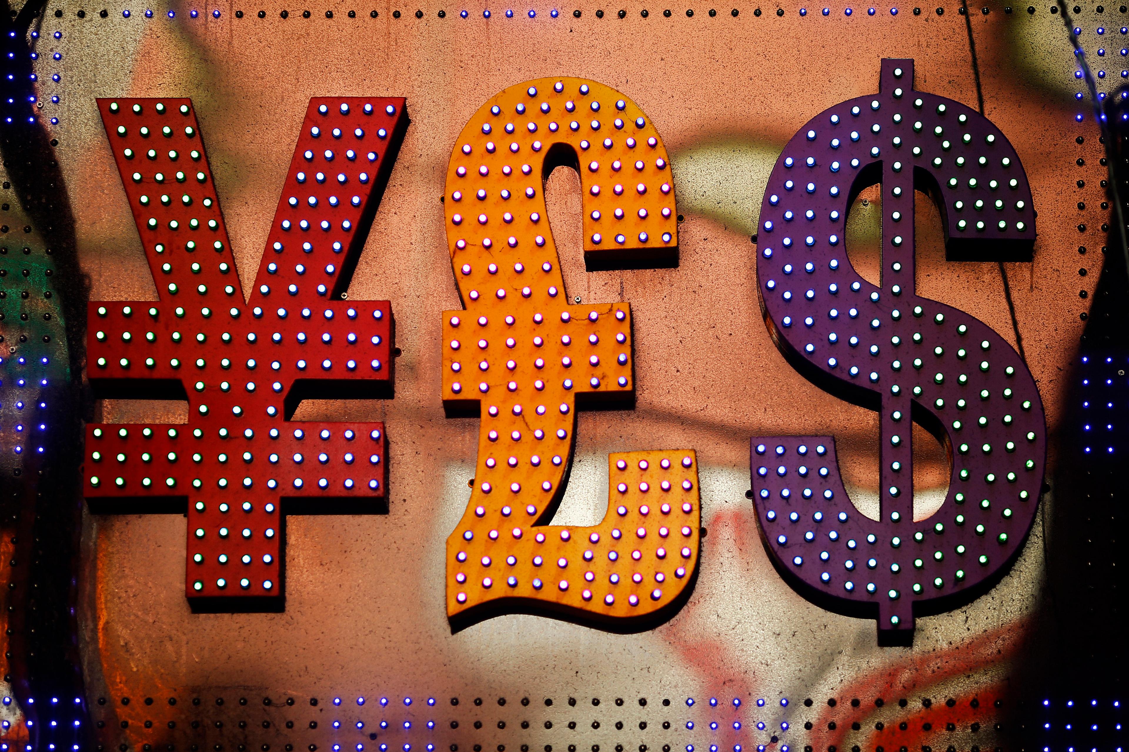 Illuminated currency symbols yen, pound and dollar in red, orange and purple on a textured background.