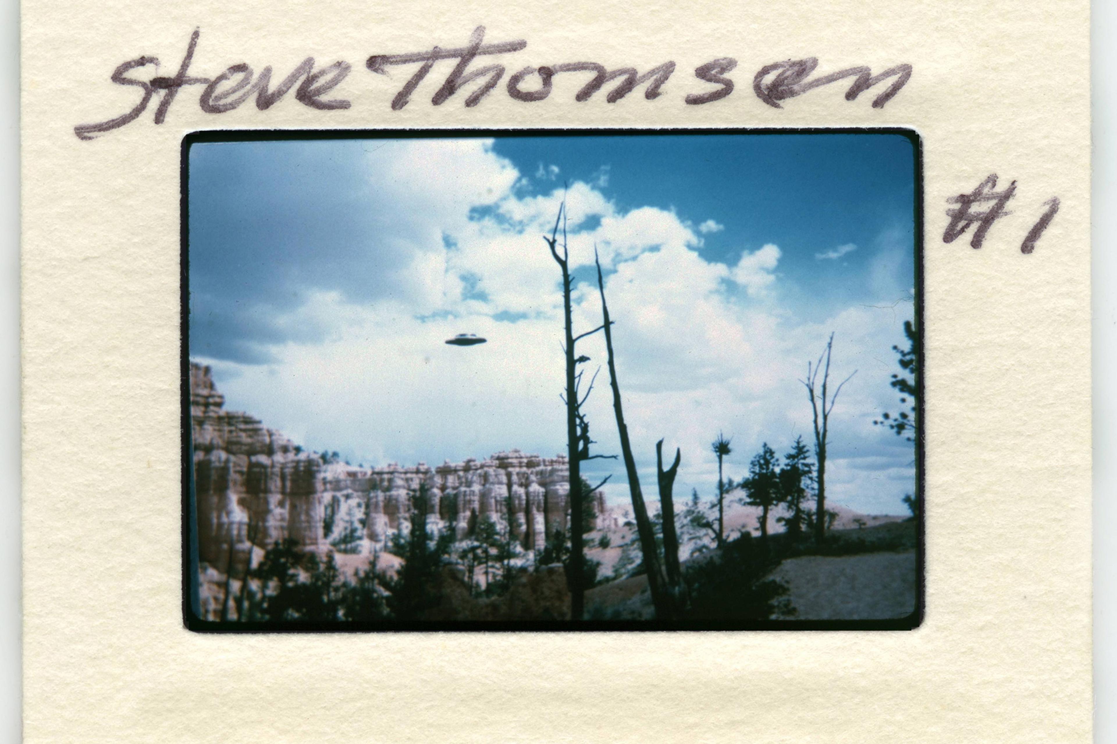 Slide photo of Bryce Canyon with UFO in sky, handwritten text on border.